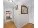 Inviting hallway featuring wooden floors and decorative art, leading to a cozy bedroom at 4212 Fairway Cir, Tampa, FL 33618