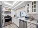 Bright kitchen features stainless steel appliances and ample counter space at 4212 Fairway Cir, Tampa, FL 33618