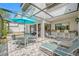 Beautiful patio featuring stone floors, seating area, a bar, and relaxing lounge chairs at 4212 Fairway Cir, Tampa, FL 33618