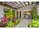 Serene patio area with comfortable seating surrounded by lush plants and landscaping at 4212 Fairway Cir, Tampa, FL 33618