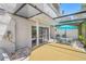 A covered patio with outdoor seating area and a hot tub, perfect for relaxation and enjoyment at 4212 Fairway Cir, Tampa, FL 33618