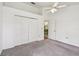 This spacious carpeted bedroom offers plenty of closet space and natural light from a window at 4645 Meadowview Cir, Sarasota, FL 34233