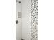 A tiled shower with gray and white accents is shown with a built-in niche for toiletries at 5118 Tennis Court Circle, Tampa, FL 33617