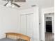 Bedroom with a wooden bed frame, double door closet and entry into the next room at 5118 Tennis Court Circle, Tampa, FL 33617