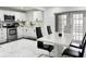 View of the dining area and kitchen with stainless steel appliances at 5118 Tennis Court Circle, Tampa, FL 33617