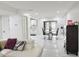 Open living area flows into dining room and kitchen with white floors and black accents at 5118 Tennis Court Circle, Tampa, FL 33617