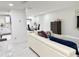 Open-concept living room and dining area with a white sectional and tile flooring at 5118 Tennis Court Circle, Tampa, FL 33617