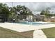 Outdoor community pool with clear blue water and surrounding fence for safety at 5118 Tennis Court Circle, Tampa, FL 33617