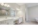 Bathroom with double vanity, modern fixtures, and a large mirror at 5152 Wildwind Dr, Apollo Beach, FL 33572