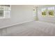 Spacious bedroom with plush carpeting and bright, sunny windows at 5152 Wildwind Dr, Apollo Beach, FL 33572