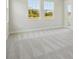 Sunny bedroom with large windows, carpet flooring, and natural light at 5152 Wildwind Dr, Apollo Beach, FL 33572