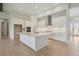 Modern kitchen with white cabinets, large island, and stainless steel appliances at 5152 Wildwind Dr, Apollo Beach, FL 33572