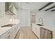 Bright, white kitchen features an island, stainless steel appliances, and subway tile backsplash at 5152 Wildwind Dr, Apollo Beach, FL 33572