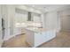 Bright, white kitchen features a spacious island and stainless steel appliances at 5152 Wildwind Dr, Apollo Beach, FL 33572