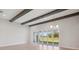 Living room with wooden beams, light wood floors and sliding glass doors at 5152 Wildwind Dr, Apollo Beach, FL 33572