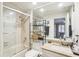 Full bathroom features a shower-tub combo and large mirror at 5335 Sand Crane Ct, Wesley Chapel, FL 33543