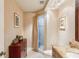 The bathroom has wallpapered walls, a vanity with storage, and a glass shower with a shower curtain at 5335 Sand Crane Ct, Wesley Chapel, FL 33543