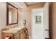 Bathroom with vanity and storage, granite countertops, and a view into a bright, tiled bathroom at 5335 Sand Crane Ct, Wesley Chapel, FL 33543