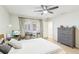Bedroom features a ceiling fan, a comfortable bed, and desk work space at 5335 Sand Crane Ct, Wesley Chapel, FL 33543