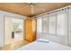 Bedroom with wood ceiling, ceiling fan, and an armoire; view into a light, bright living room at 5335 Sand Crane Ct, Wesley Chapel, FL 33543