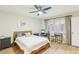 Bedroom features a ceiling fan, a comfortable bed, and shutters at 5335 Sand Crane Ct, Wesley Chapel, FL 33543