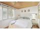 This bedroom features a wood ceiling, a ceiling fan, and a window that provides natural light at 5335 Sand Crane Ct, Wesley Chapel, FL 33543