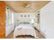 This bedroom features a wood ceiling, a ceiling fan, and built in shelving to the right of the bed at 5335 Sand Crane Ct, Wesley Chapel, FL 33543