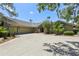 Spacious home featuring a large driveway, mature trees, and a well-maintained exterior at 5335 Sand Crane Ct, Wesley Chapel, FL 33543