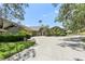 Beautiful single-story home with a circular driveway, mature landscaping, and a welcoming facade at 5335 Sand Crane Ct, Wesley Chapel, FL 33543