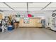 The garage features a bike, storage shelves, and built-in cabinets for storing tools and other items at 5335 Sand Crane Ct, Wesley Chapel, FL 33543