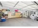 Spacious garage features built-in storage cabinets, a utility sink and epoxy floors at 5335 Sand Crane Ct, Wesley Chapel, FL 33543