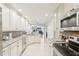 Bright kitchen features white cabinetry, stainless steel appliances, and granite countertops at 5335 Sand Crane Ct, Wesley Chapel, FL 33543