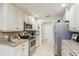 Modern kitchen with stainless steel appliances, granite countertops, and ample cabinet space at 5335 Sand Crane Ct, Wesley Chapel, FL 33543