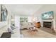 Comfortable living room featuring a fireplace, neutral tones, and access to outdoor views at 5335 Sand Crane Ct, Wesley Chapel, FL 33543