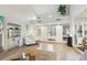 Bright and airy living room with vaulted ceilings, wet bar, neutral tile floors, and sliding barn door at 5335 Sand Crane Ct, Wesley Chapel, FL 33543