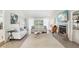 Cozy living room with fireplace, large windows with lots of natural light, and neutral colored sofas at 5335 Sand Crane Ct, Wesley Chapel, FL 33543