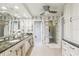 Ensuite bathroom features double sink vanity and shower room at 5335 Sand Crane Ct, Wesley Chapel, FL 33543