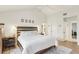 Bright main bedroom features wood floors, ceiling fan, and ensuite bath at 5335 Sand Crane Ct, Wesley Chapel, FL 33543