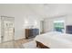 Bright main bedroom features wood floors, ceiling fan, and ensuite bath at 5335 Sand Crane Ct, Wesley Chapel, FL 33543