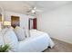 Comfortable bedroom featuring white walls, plush bedding, an area rug, and soft, natural lighting at 5890 38Th N Ave # 305, St Petersburg, FL 33710