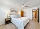 Comfortable bedroom with a ceiling fan, plush bedding, decorative pillows, and en-suite bathroom at 5890 38Th N Ave # 305, St Petersburg, FL 33710