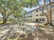 A beautiful courtyard featuring mature trees, outdoor seating, and a well-maintained lawn offers a relaxing outdoor space at 5890 38Th N Ave # 305, St Petersburg, FL 33710