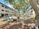 An expansive courtyard with outdoor seating areas and mature trees provides a tranquil outdoor living space at 5890 38Th N Ave # 305, St Petersburg, FL 33710