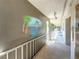 Outdoor hallway featuring neutral walls, mural art, overhead lighting, and a white metal guardrail at 5890 38Th N Ave # 305, St Petersburg, FL 33710