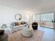 Bright living room with neutral furniture, access to the lanai and view to the bedroom at 5890 38Th N Ave # 305, St Petersburg, FL 33710