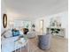 Well-lit living room featuring neutral tones, stylish furniture and a view of the bedroom at 5890 38Th N Ave # 305, St Petersburg, FL 33710