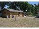 Side view of the backyard featuring a shed, and ample space for gardening and recreation at 601 W College Ave, Ruskin, FL 33570