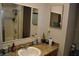 Bathroom featuring tiled vanity, a large mirror, and well-maintained fixtures at 601 W College Ave, Ruskin, FL 33570