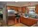 Functional kitchen with stainless steel appliances, wood cabinets, and a practical layout at 601 W College Ave, Ruskin, FL 33570