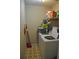Practical laundry room with appliances, storage shelves, and tiled flooring at 601 W College Ave, Ruskin, FL 33570